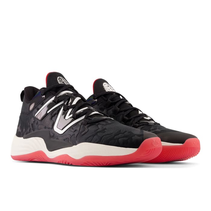 View of black, white, and red New Balance shoes.